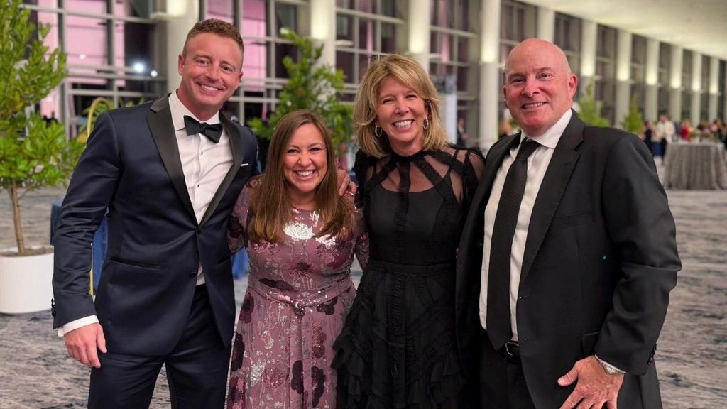 Four BPD team members in evening wear outside a charity event