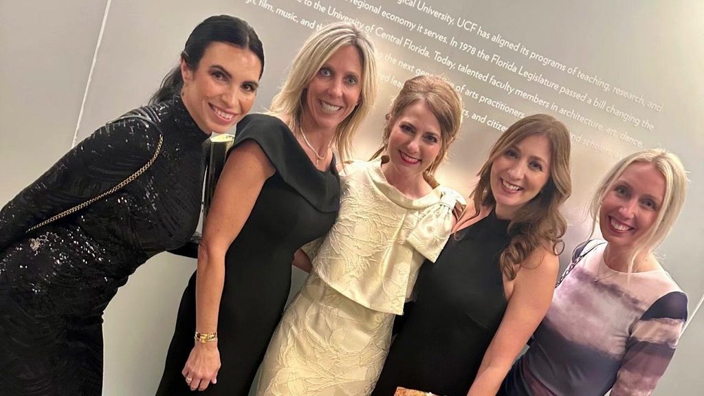 Five BPD team members smiling together at a charity gala
